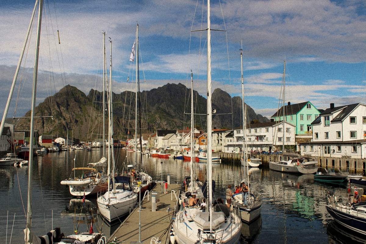 Sailing boats moored in Henningsvær marina on a sunny summer day, Lofoten