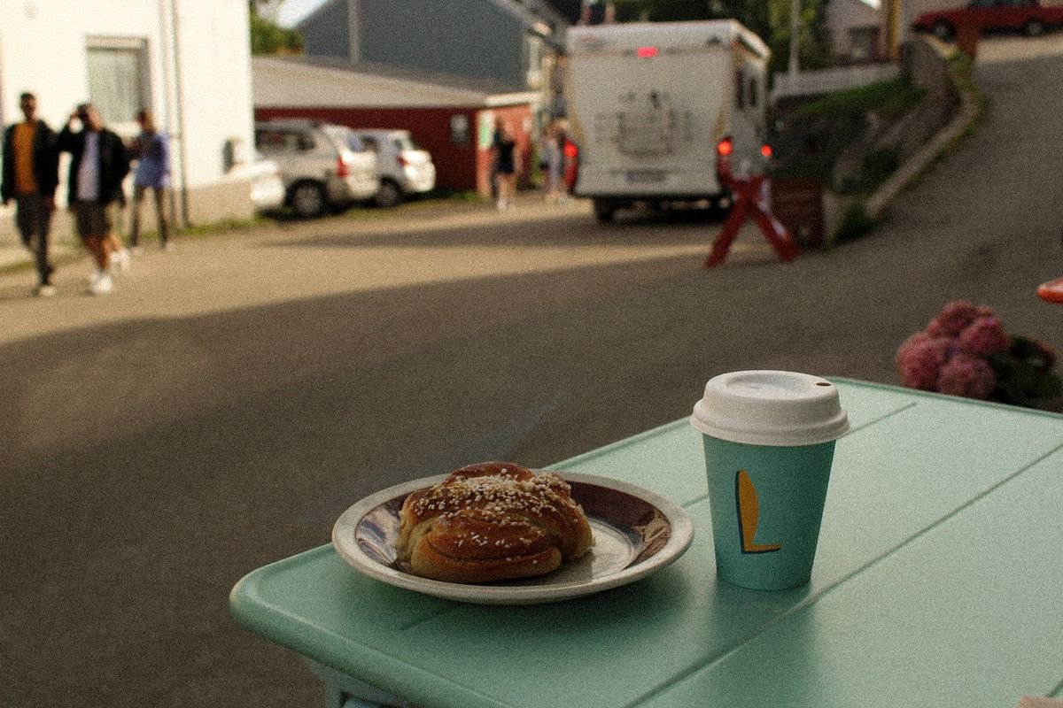 Cinnamon bun and coffee on a café table in Lofoten