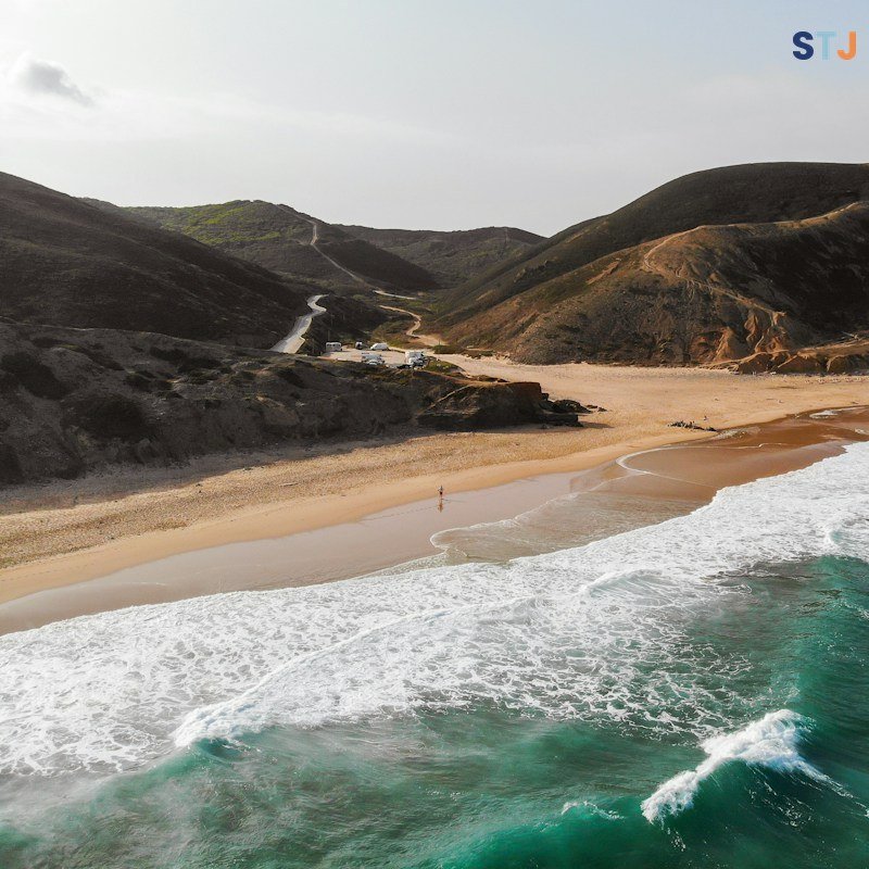 Campsite pitch on a hill overlooking woodland in the Costa Vicentina Natural Park, southern Portugal.